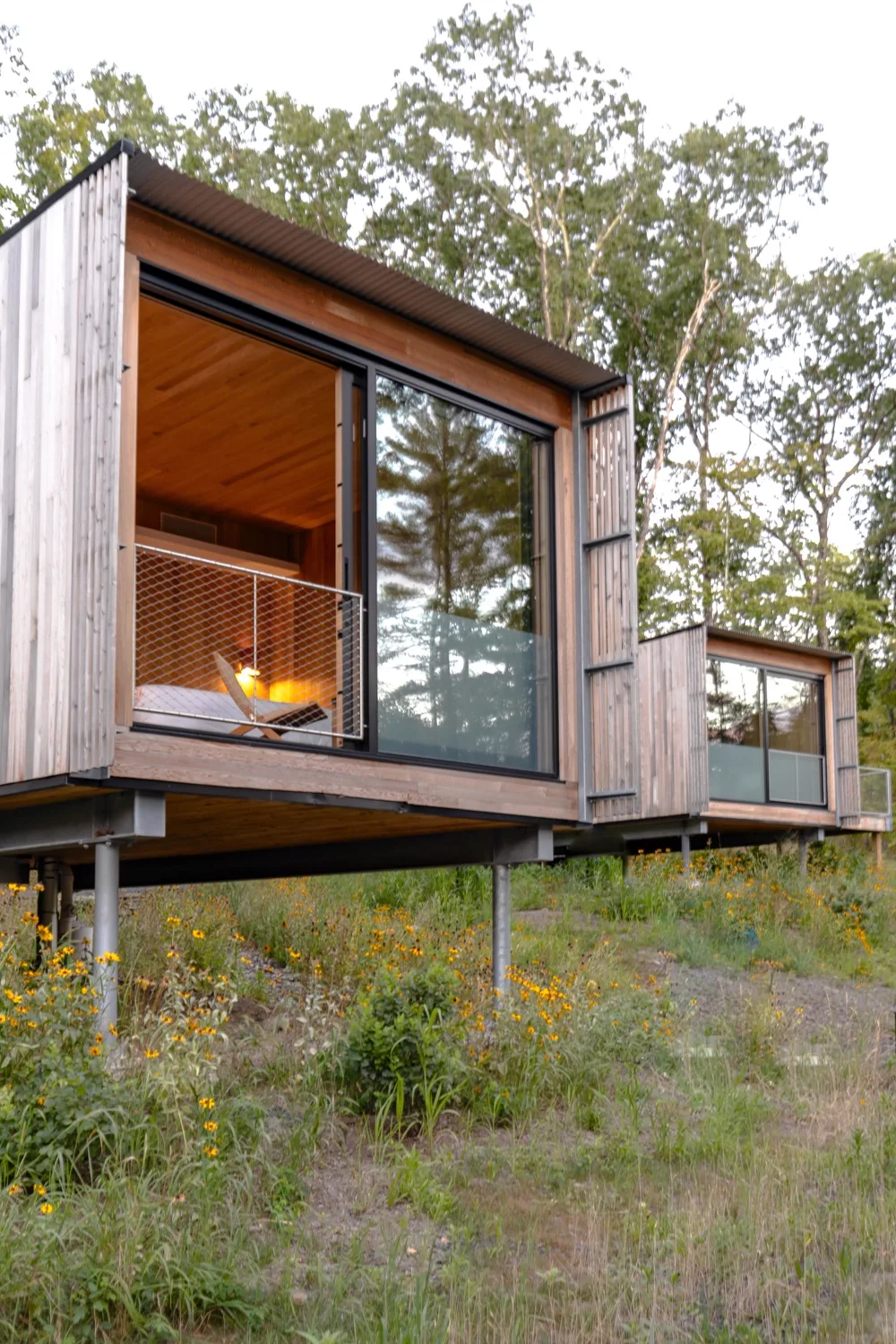 Cabine en bois contemporaine, surélevée au milieu des arbres